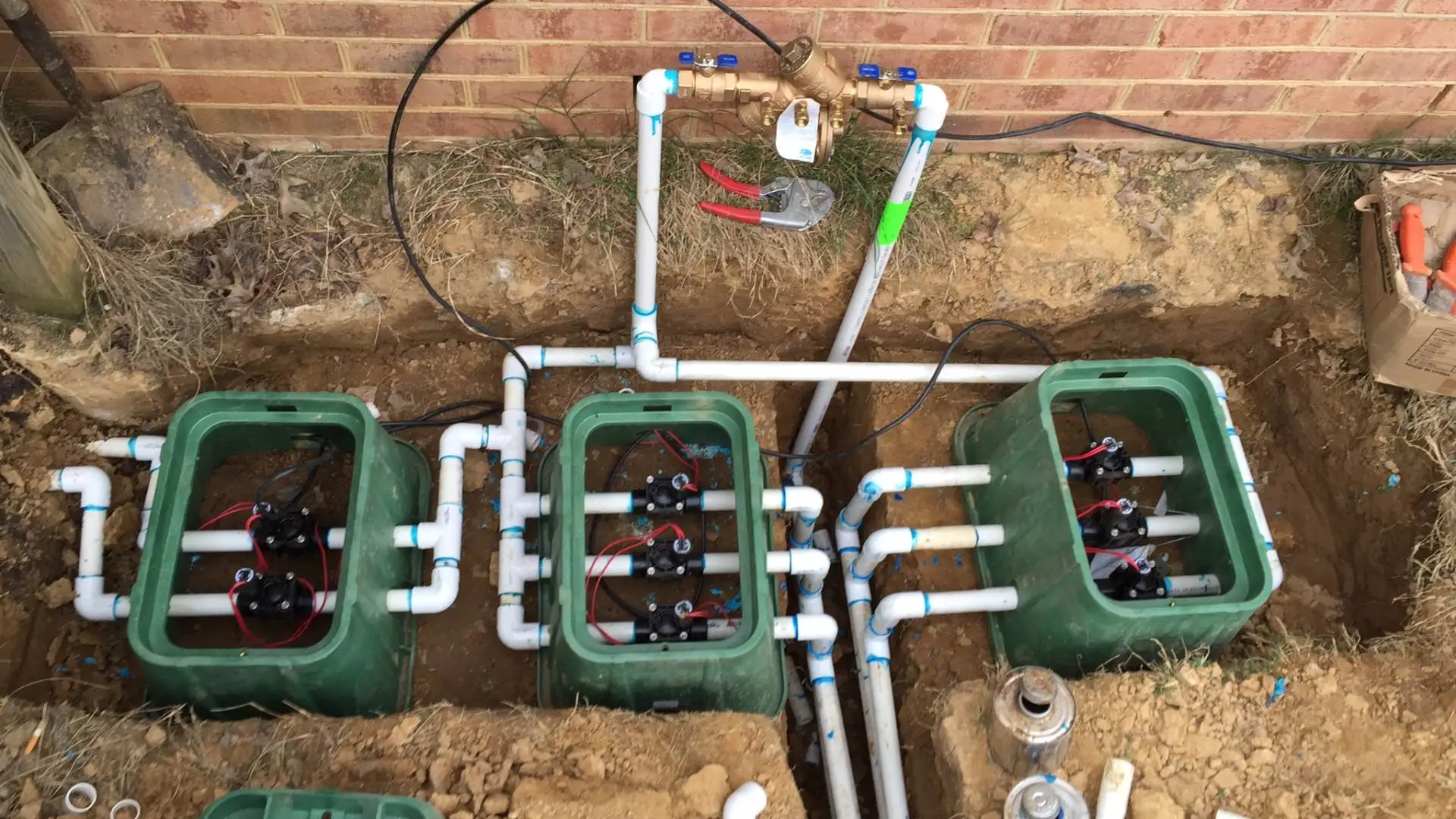Irrigation professional performing irrigation maintenance on sprinkler components near Germantown, TN.