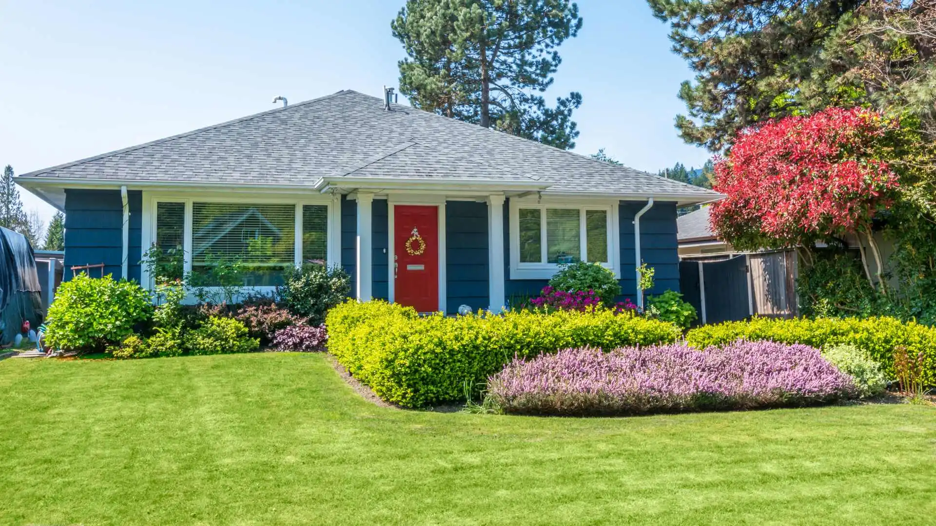 Landscape bed with maintained lawn for home front in Eads, TN.