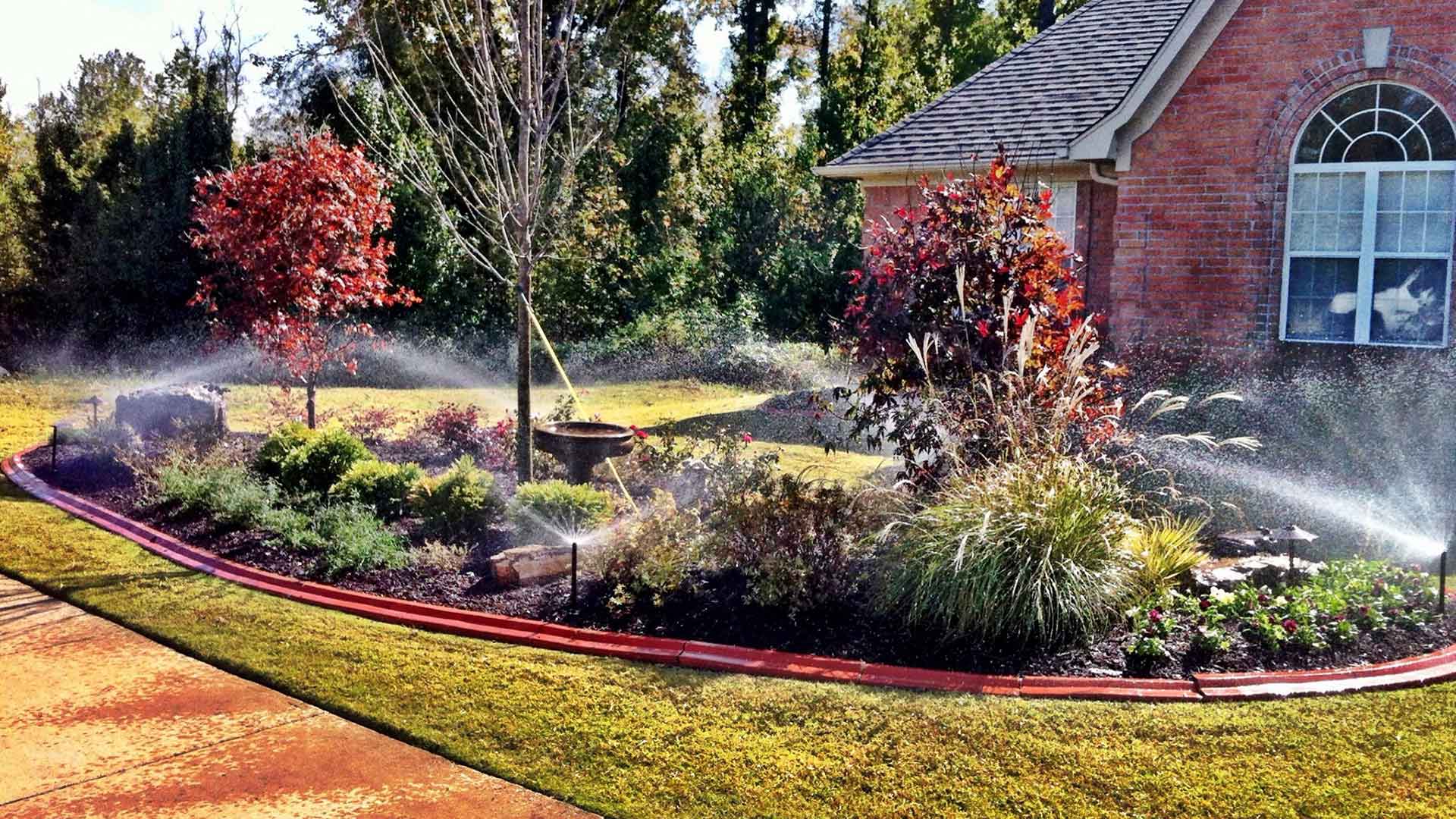 New landscape bed renovation being watered at a home in Bartlett, TN.