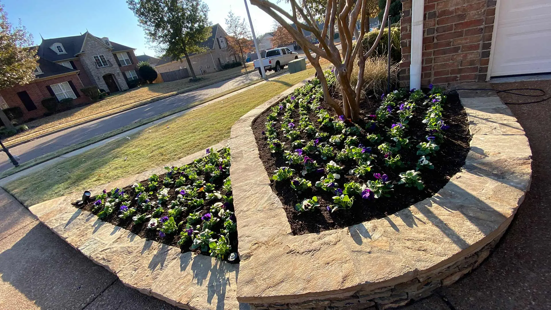 New landscape bed with plantings inside a retaining wall near Lakeland, TN.