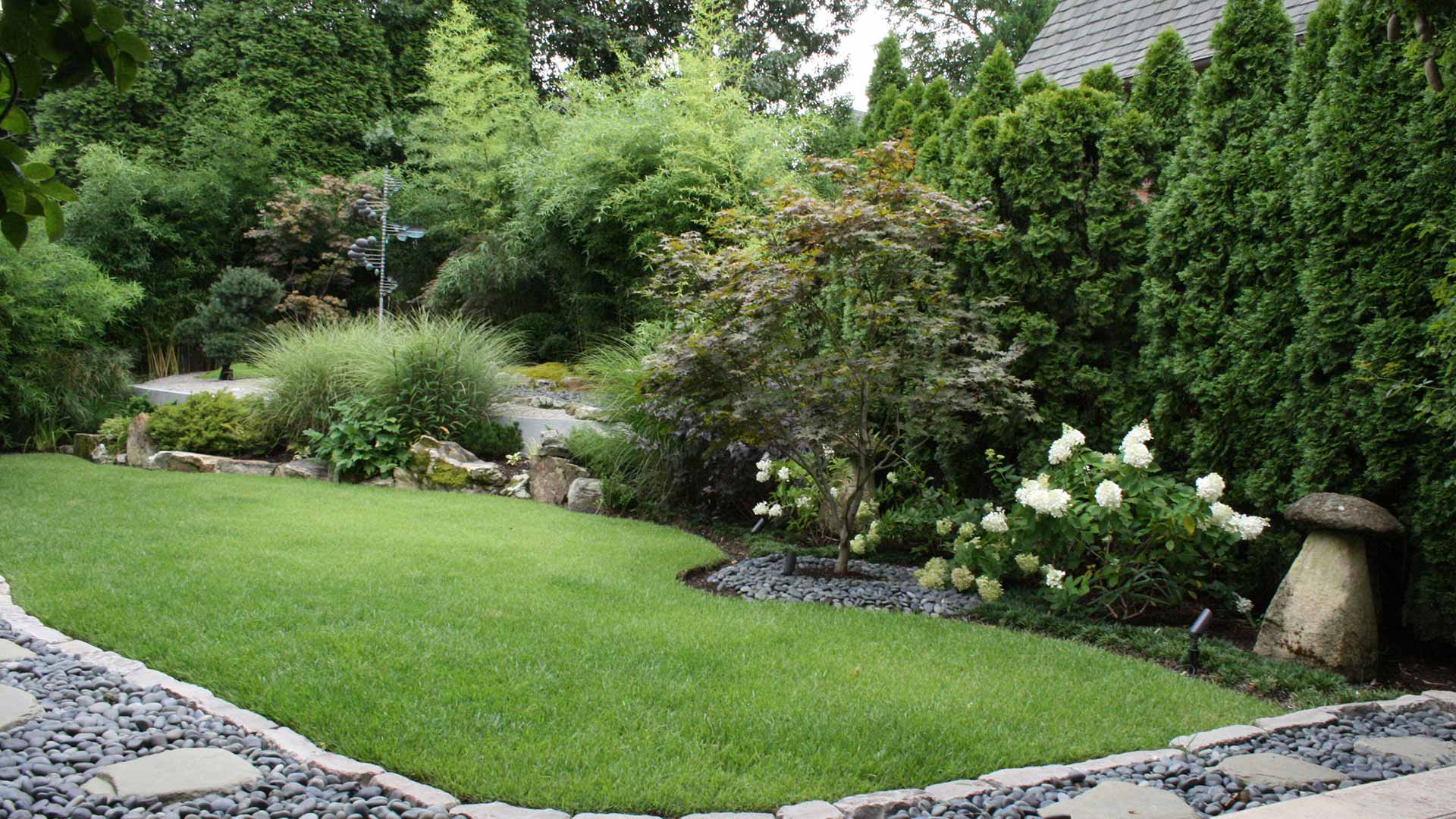 Yard with lush, green lawn and beautiful landscaping in Bartlett, TN.