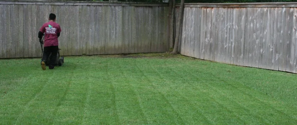 Crew mowing a lush green lawn in Memphis, TN.