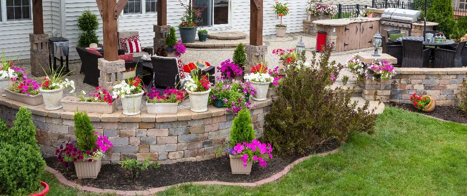 Retaining wall and a patio in Memphis, TN, with potted flowers.