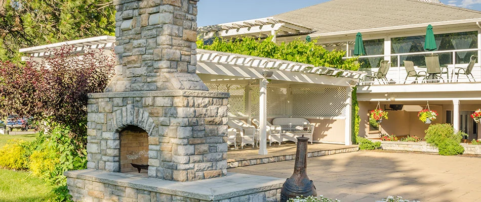 A stone fireplace built on a patio behind a home in Bartlett, TN.