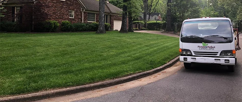 Picture Perfect Landscapes work truck at a recently fertilized yard in Bartlett, TN.