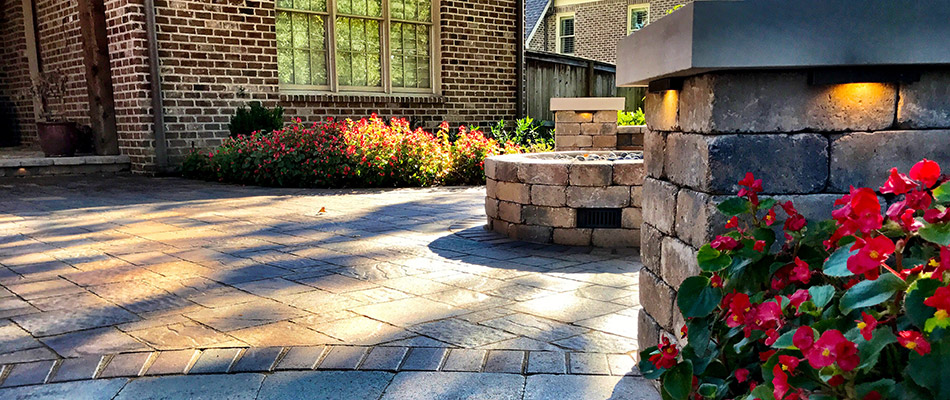 A stone fire pit surrounded by retaining walls in Arlington, TN.