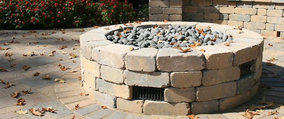 A gas burning fire pit installed with rocks as covering in Sea Isle Park, TN.