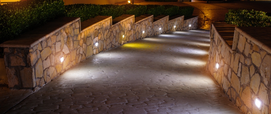 A grazing lighting technique added to textured walkway in Germantown, TN.