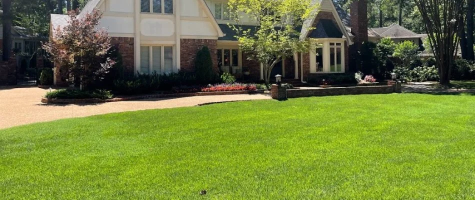 Residential lawn with green grass and long walkway in Memphis, Tennessee.