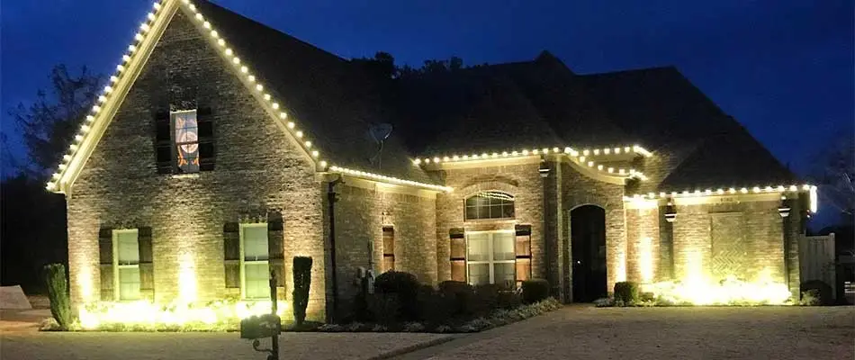 Collierville, TN home with holiday lighting installed on the roofline.