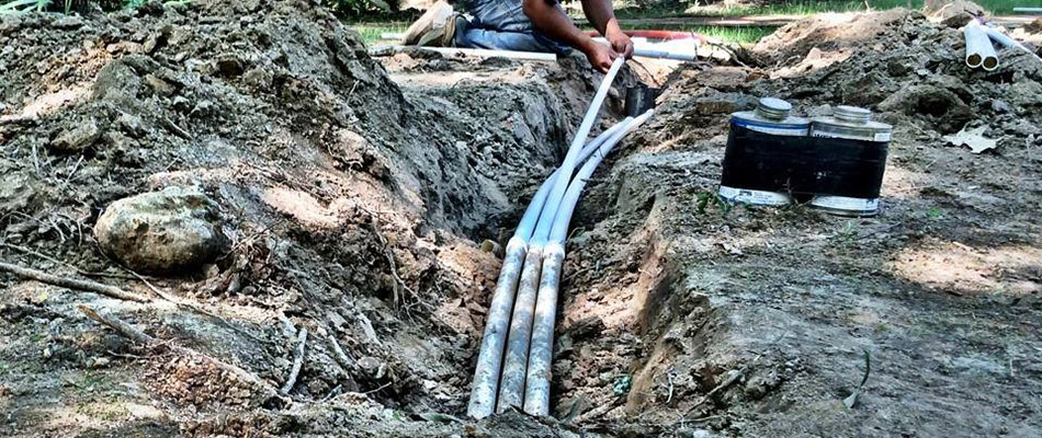 Our specialist installing an irrigation system on a property in Eads, TN.