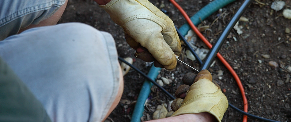 Irrigation professional performing repairs on irrigation wires near Bartlett, TN.