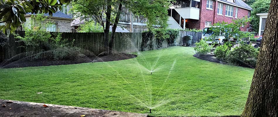 Irrigation sprinklers watering a home lawn in Arlington, TN.