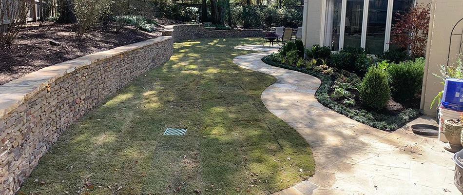 A long retaining wall built along a property in Eads, TN.