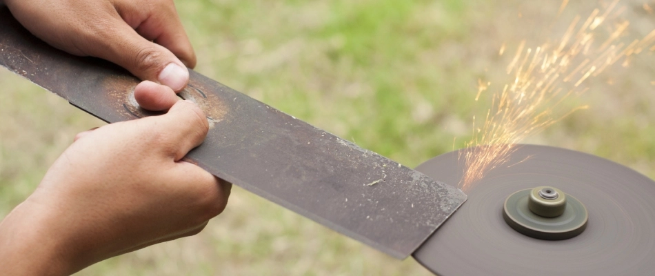 Mower blades being sharpened by a professional in Midtown Memphis, TN.