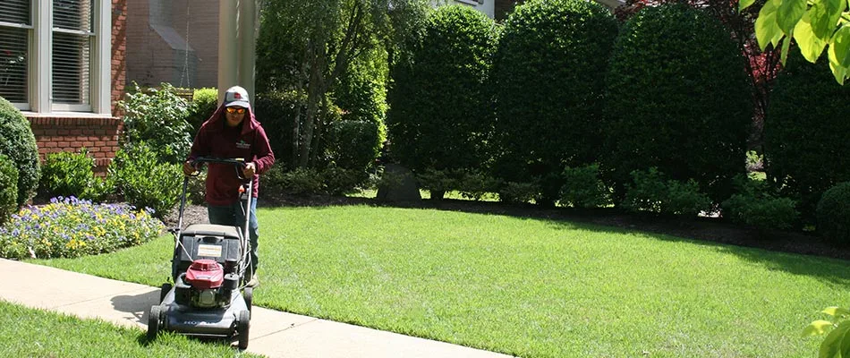 Mowing a lawn in diagonal lines at a home in Lakeland, TN.