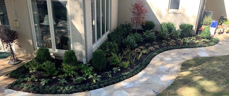 A landscape bed topped with mulch alongside a home in Midtown Memphis, TN.