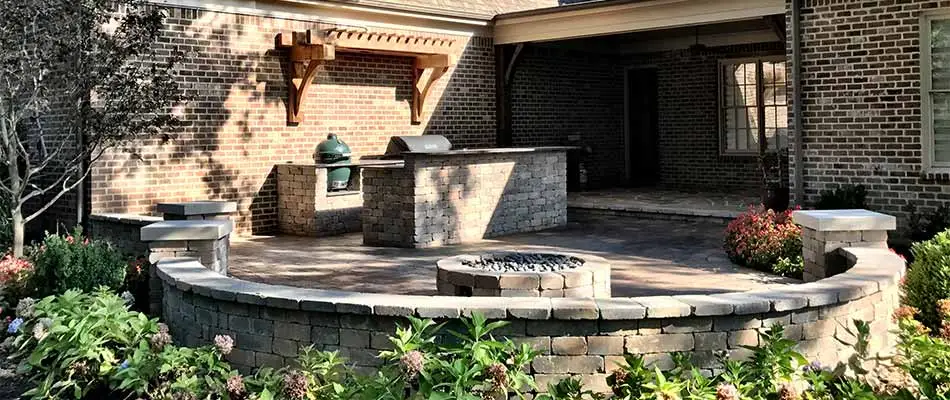Outdoor kitchen beside patio and fire pit area in East Memphis, TN.