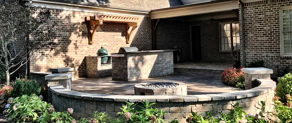 Outdoor living space installed with kitchen and fire pit in Memphis, TN.