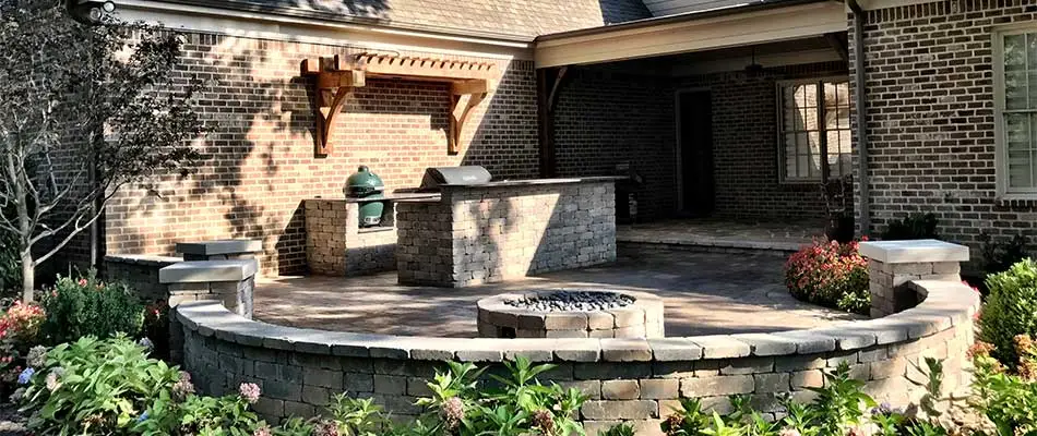 Outdoor living space with an outdoor kitchen, fire pit, and patio in Memphis, TN.