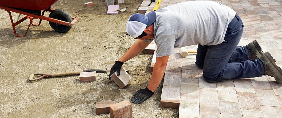 Professional placing bricks in a running bond pattern in Collierville, TN.