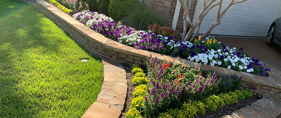 Retaining wall and landscape bed with annual flowers near Bartlett, TN.