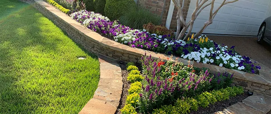 Retaining wall and landscape bed with annual flowers near Bartlett, TN.