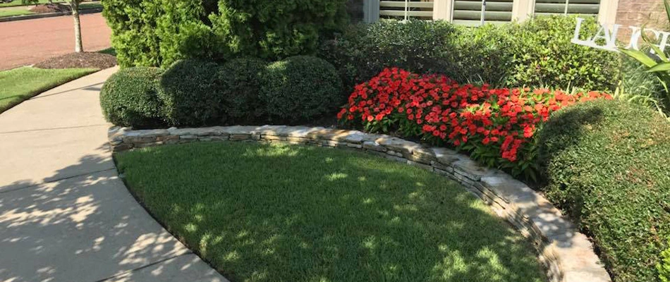 Landscape bed maintained and retaining wall installed for a property in Cooper-Young, TN.