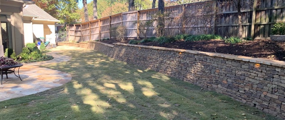 Stone retaining wall built for backyard in Eads, TN.